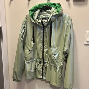 Metallic green raincoat with hood two pockets, drawstring around waist